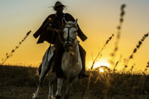 Sertanejo cearense montado a cavalo com paisagem do sertão ao fundo