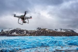 Drone with a camera is flying on iceberg.
