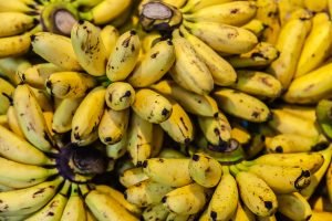 Fresh ripe organic Banana on silver aluminum background. Bright yellow ripe bananas to eat on the silver aluminum table